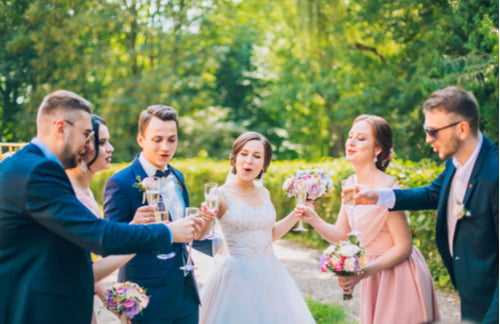 bride and groom toasting with wedding party