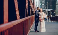 a couple taking wedding photos in the city