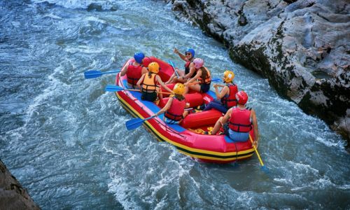 A group of people whitewater rafting