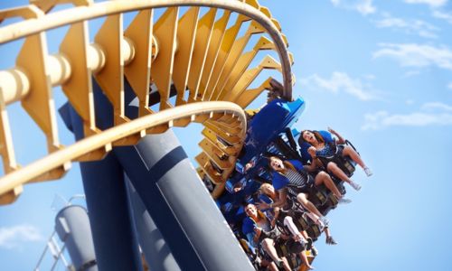 People strapped into a rollercoaster at an amusement park