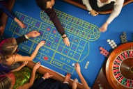 a group of people play together at a casino table