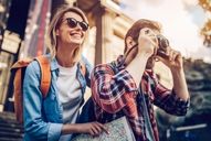 a tourist couple taking pictures and smiling