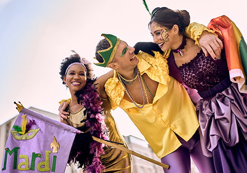 A group of party-goers in flashy clothes celebrate Mardi Gras in Louisiana