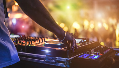 Close-up of DJ's hands playing music