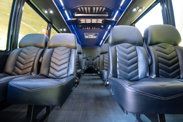 Shuttle bus rental interior with rows of leather seats